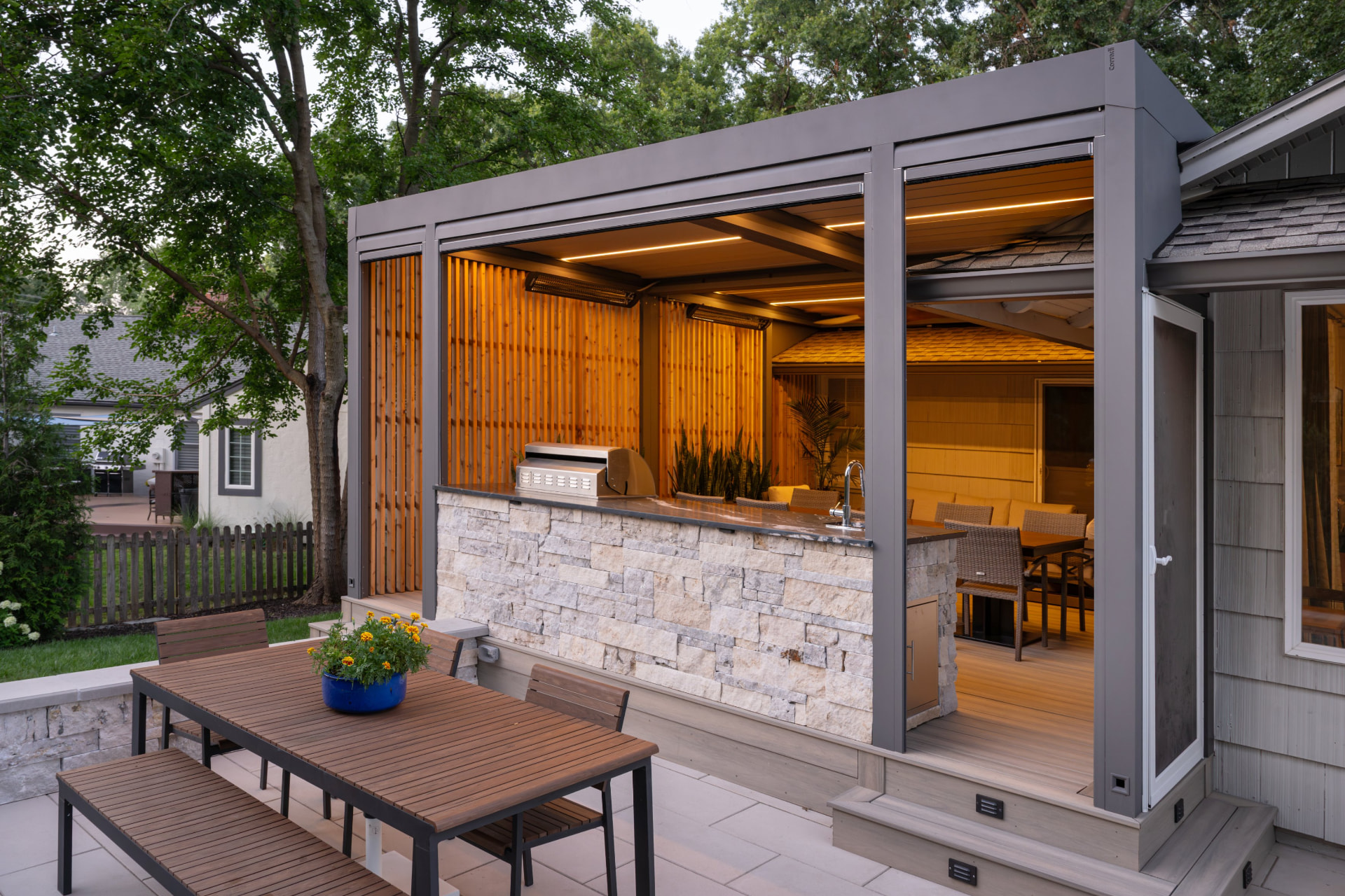 Outdoor kitchen and pergola at dusk